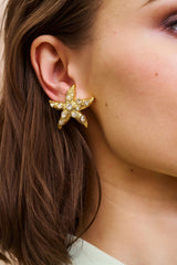 Kenneth Jay Lane Crystal Starfish Earrings in clip ons on model